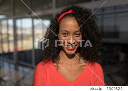 Front view of female executive looking at camera in office 53003294
