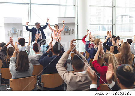 Business people applauding and celebrating in a business seminar 53003536