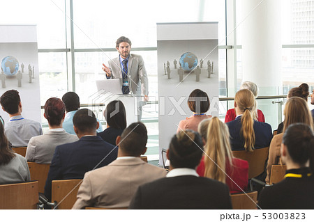 Male speaker with laptop speaks in a business seminar 53003823
