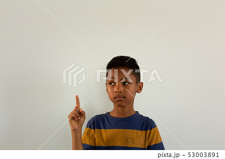 Thoughtful boy pointing his finger up Thoughtful boy pointing his finger up 53003891