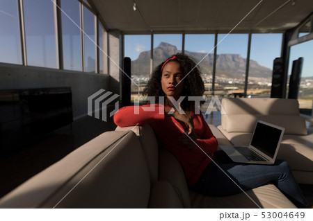 Female executive sitting with laptop in office Female executive sitting with laptop in office 53004649