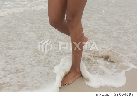 African-American woman walking on the beach African-American woman walking on the beach 53004695