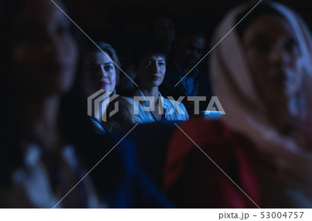 Businesswoman holding laptop and listening to the presentation in auditorium 53004757