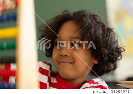 Boy learning mathematics with abacus in a classroom 53004971
