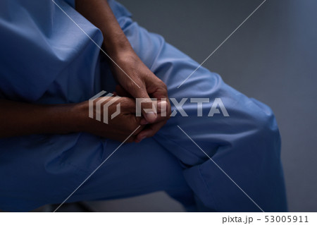Surgeon sitting with hand clasped at hospital 53005911