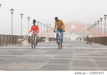 Couple riding bicycle at promenade on a sunny day 53005957