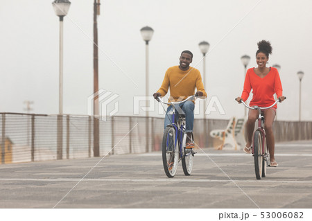 Couple riding bicycle at promenade on a sunny day 53006082