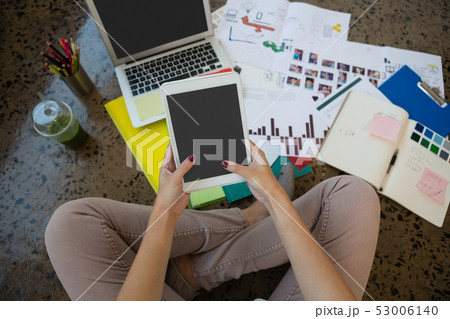 Woman using digital tablet at office Woman using digital tablet at office 53006140