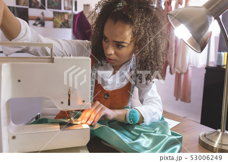 Female fashion designer working with sewing machine 53006249