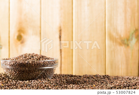 Raw lentil grains in glass bowl Raw lentil grains in glass bowl 53007824