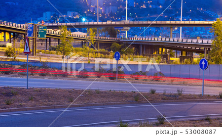 View of city highway in dusk with trace of blurred headlights 53008087