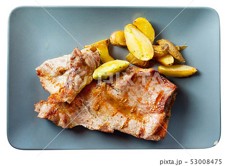Picture of delicious fried iberian pork with fried potatoes at plate 53008475