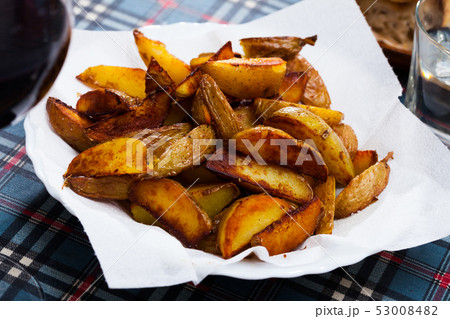Delicious baked in oven yellow potatoes served at plate 53008482