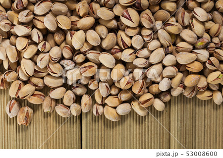 Pistachios on wooden surface 53008600