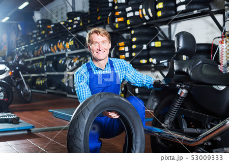 Man working with bike tires Man working with bike tires 53009333
