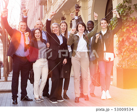 Men and women posing on street of city 53009534