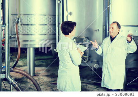 Wine maker shows equipment on winery Wine maker shows equipment on winery 53009693