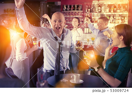 Businessman having fun at corporate party Businessman having fun at corporate party 53009724
