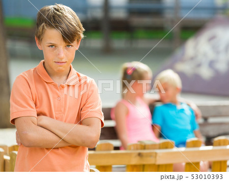 Portrait of boy 9-12 years old which is taking offense on his friends 53010393