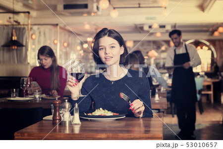 Woman enjoying dinner alone in restaurant Woman enjoying dinner alone in restaurant 53010657