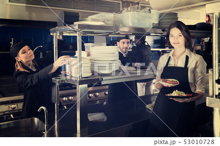 Portrait of adult waiter standing with order Portrait of adult waiter standing with order 53010728