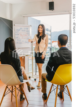 Asian busiensswoman presenting the big data over the chart to teamwork colleagues in modern office, people business group and team building concept. 53010892