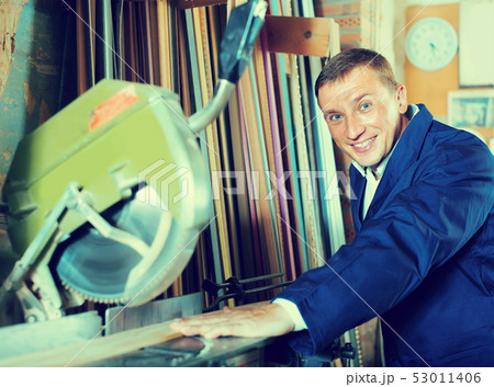 happy workman cutting wooden planks using circular saw happy workman cutting wooden planks using circular saw 53011406
