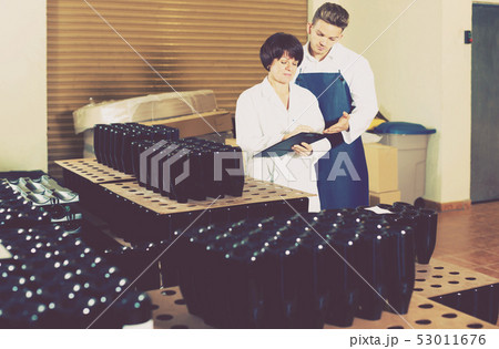 Employees checking number of wine bottles Employees checking number of wine bottles 53011676