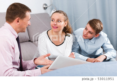 Mother and son signing documents Mother and son signing documents 53011951