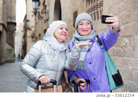 Elderly women tourists making selfie with phone Elderly women tourists making selfie with phone 53012254