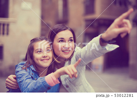 Adult mother pointing to daughter new sight Adult mother pointing to daughter new sight 53012281