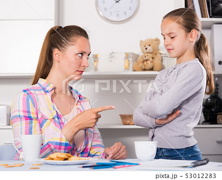 Young mother scolding her daughter Young mother scolding her daughter 53012283