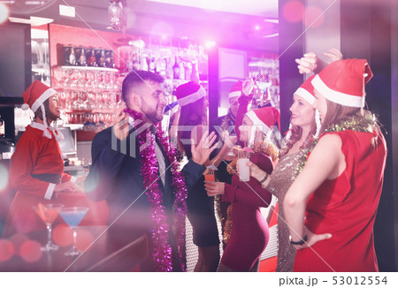Guy with two girls on new year party in bar 53012554