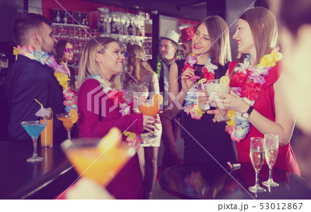 Colleagues on corporate Hawaiian party in bar Colleagues on corporate Hawaiian party in bar 53012867