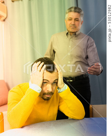 Adult father teaches his son 53012982