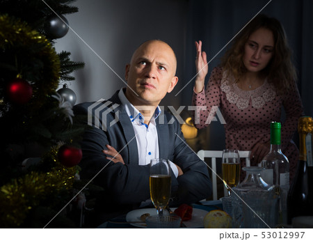 Couple quarreling at Christmas night 53012997