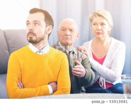 Grandfather instructs grandson 53013081