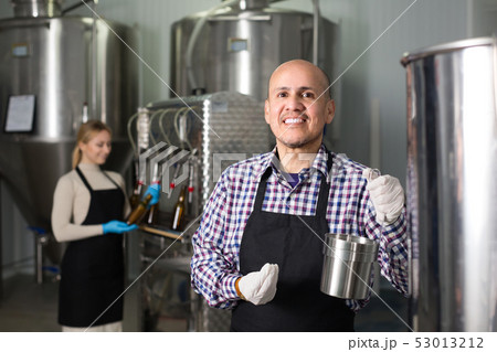 Man working on modern brewery. 53013212