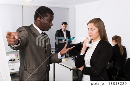 Angry boss dismissing frustrated female Angry boss dismissing frustrated female 53013229
