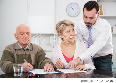 Woman and eldery man with bank employee 53013230