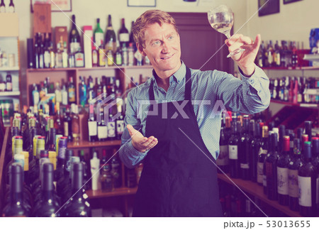 Seller man in wine store Seller man in wine store 53013655