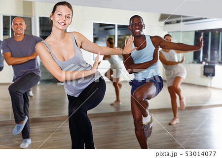Cheerful people practicing vigorous lindy hop movements in dance class 53014077