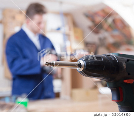 guy using drilling machine at workshop guy using drilling machine at workshop 53014300