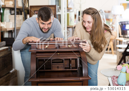 Couple satisfied with purchase of writing cabinet Couple satisfied with purchase of writing cabinet 53014315