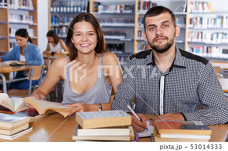 female and male students working in university library female and male students working in university library 53014333
