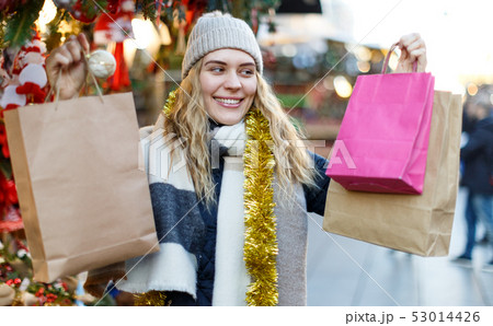Woman holding bags with Christmas toys Woman holding bags with Christmas toys 53014426
