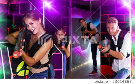 Young team playing laser tag game Young team playing laser tag game 53014867