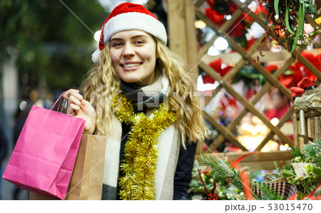 Girl holding paper bags at Christmas fair 53015470