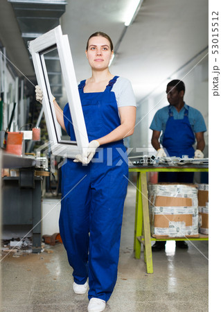 Young woman master is looking on modern window frame Young woman master is looking on modern window frame 53015512