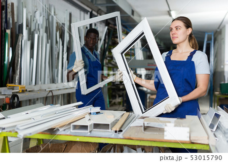 Young woman master is looking on modern window frame 53015790